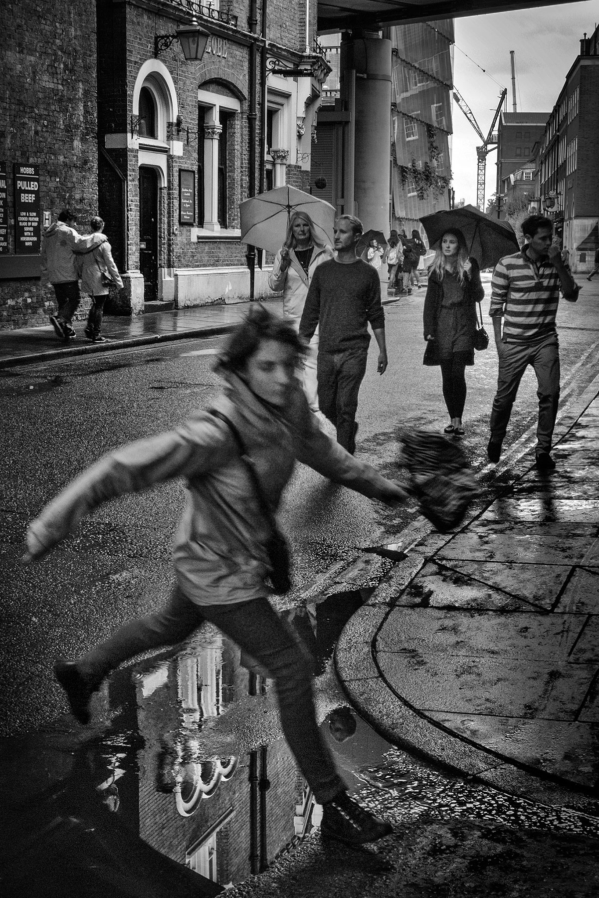 A black and white street photograph made with a compact camera or phone.