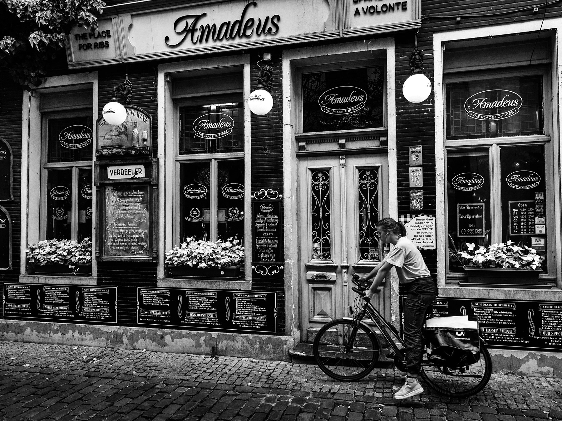 A black and white street photograph made with a compact camera or phone.