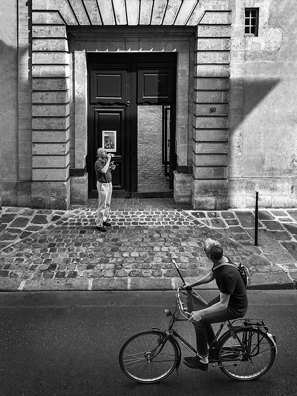 A black and white street photograph made with a compact camera or phone.