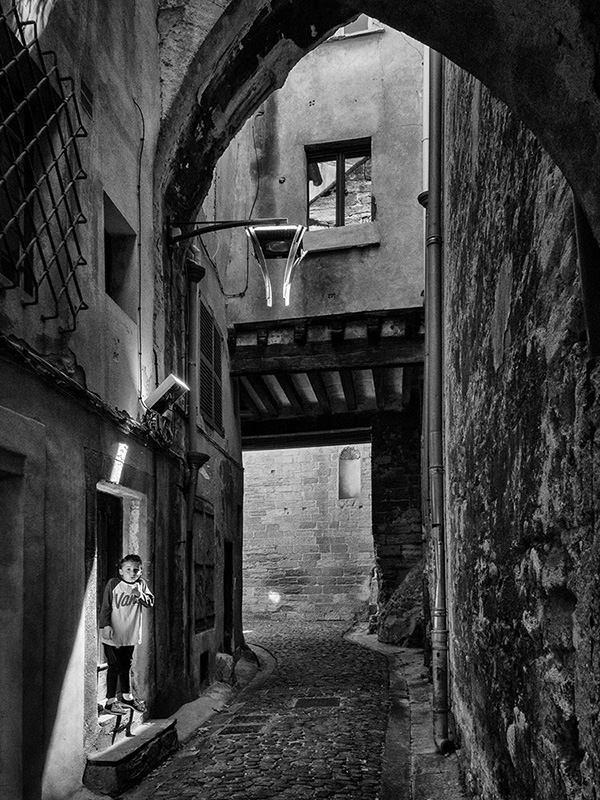 A black and white street photograph made with a compact camera or phone.