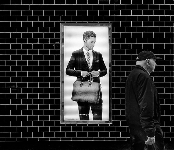 A black and white street photograph made with a compact camera or phone.