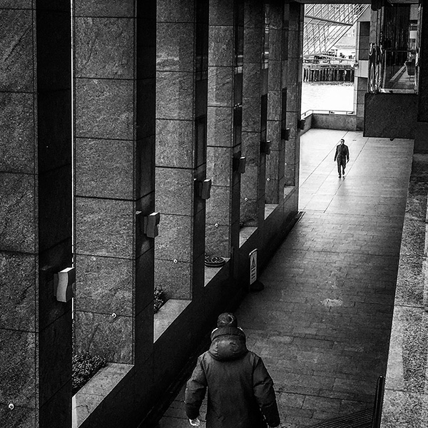A black and white street photograph made with a compact camera or phone.