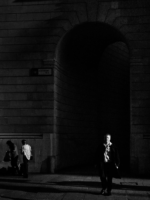 A black and white street photograph made with a compact camera or phone.