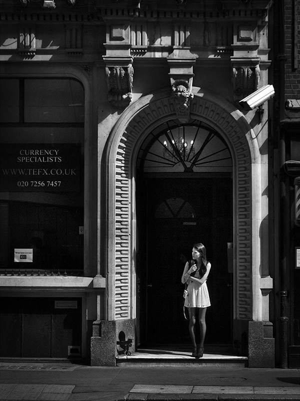 A black and white street photograph made with a compact camera or phone.