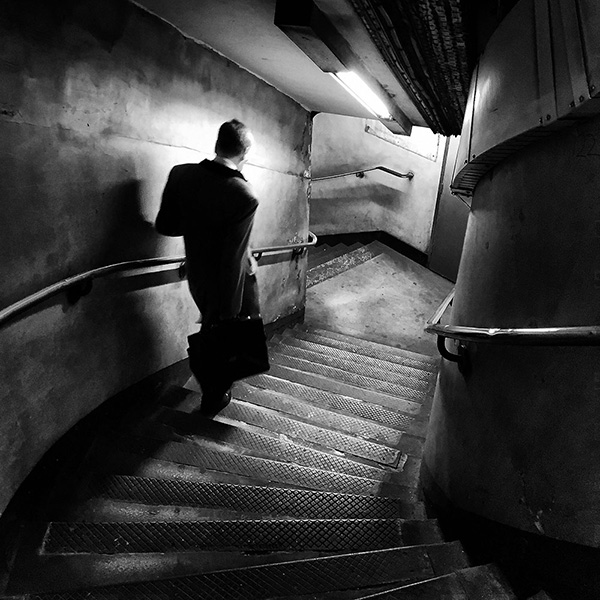 A black and white street photograph made with a compact camera or phone.