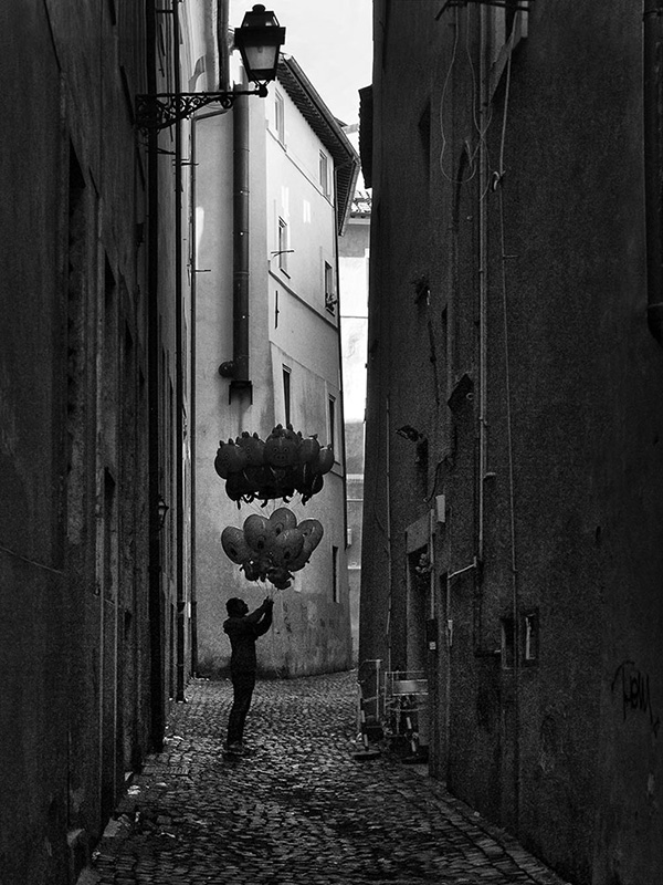 A black and white street photograph made with a compact camera or phone.