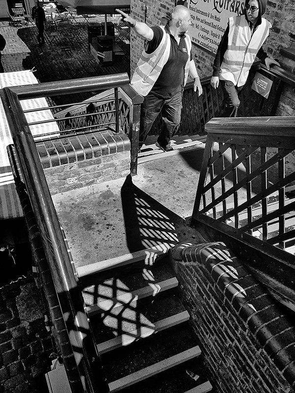 A black and white street photograph made with a compact camera or phone.